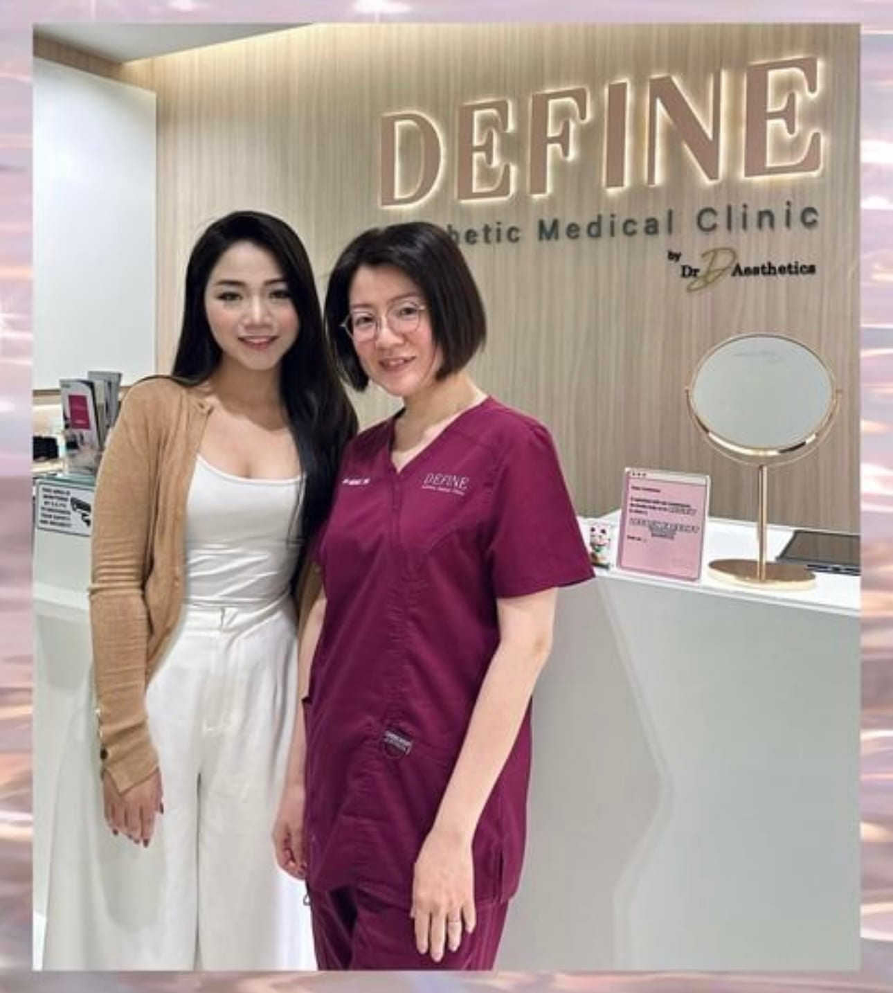Dr Michelle Tan and team inside Define Aesthetic Clinic with illuminated reception sign and pale oak panelling